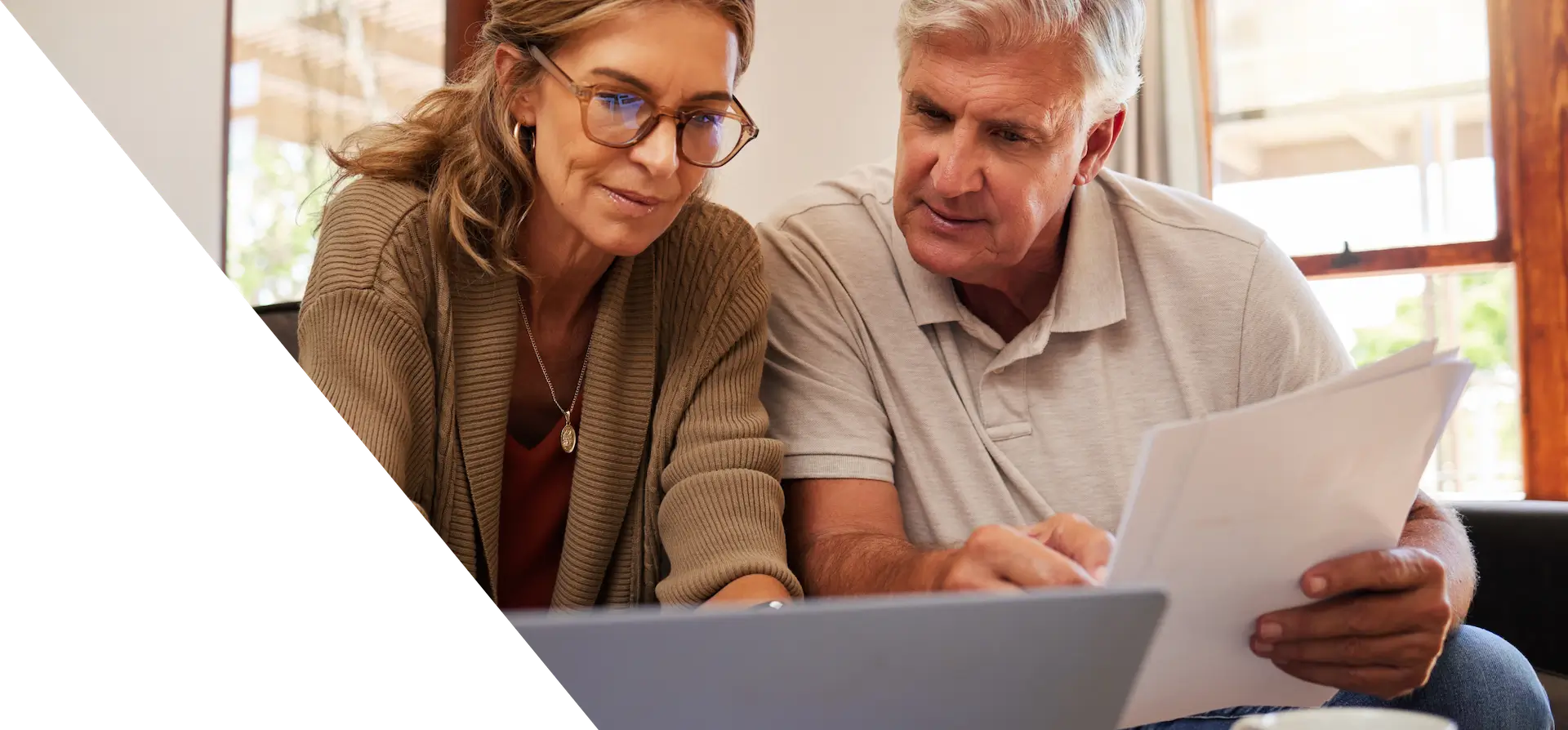 man and woman looking at a laptop screen
